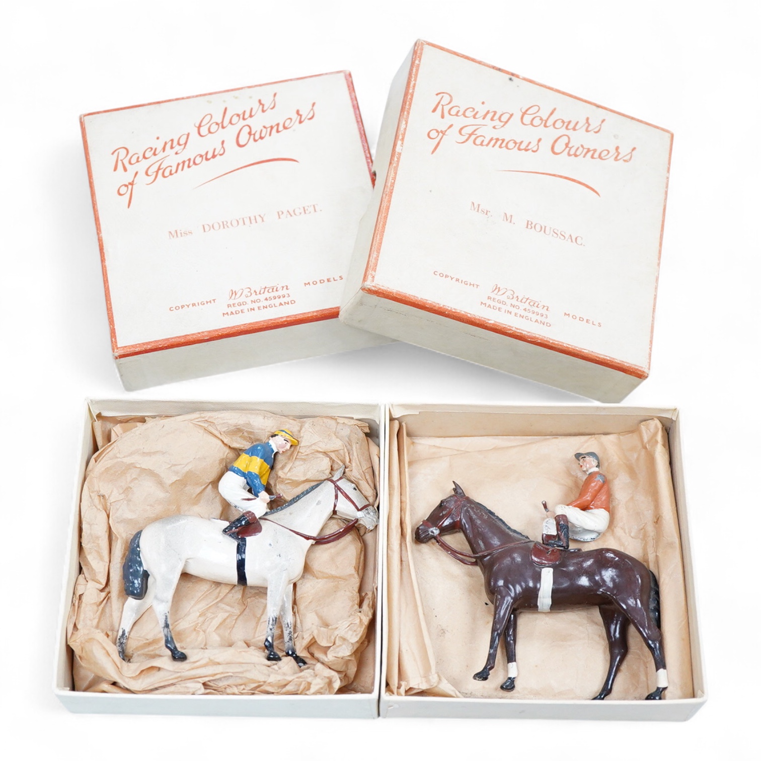 Two boxed Britains Racing Colours of Famous Owners series lead mounted figures; Miss Dorothy Paget - rider in yellow-striped blue jersey on a grey horse, and Msr. M. Boussac - rider in orange jersey on a dark brown horse